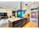 Kitchen island featuring granite countertop, gas cooktop, oven, and modern design elements at 1329 E Catalina Dr, Phoenix, AZ 85014