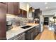 A modern kitchen featuring stainless steel appliances, stylish backsplash, and granite counters at 1329 E Catalina Dr, Phoenix, AZ 85014