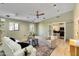 An airy living room showcasing wood floors, a ceiling fan, and modern furnishings at 1329 E Catalina Dr, Phoenix, AZ 85014