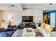 Comfortable living room with modern decor, featuring a large TV, plush seating, and stylish rug at 1329 E Catalina Dr, Phoenix, AZ 85014