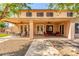 Large covered back patio with multiple seating areas and access to the home's interior at 14107 W Christy Dr, Surprise, AZ 85379