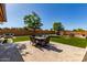 Inviting backyard with patio, dining set, playset, and fire pit, perfect for outdoor living and entertaining at 14107 W Christy Dr, Surprise, AZ 85379
