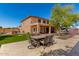 Expansive backyard featuring a dining table set, patio, and artificial grass, perfect for outdoor dining at 14107 W Christy Dr, Surprise, AZ 85379