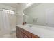 Bathroom features a shower-tub combo, and a vanity with mirror at 14107 W Christy Dr, Surprise, AZ 85379