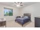 Bedroom with ceiling fan, window, dark furniture, and carpet floors at 14107 W Christy Dr, Surprise, AZ 85379