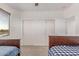 Bedroom featuring two twin beds, sliding closet, and window at 14107 W Christy Dr, Surprise, AZ 85379
