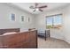 Bright bedroom with a ceiling fan, three windows, and two twin beds at 14107 W Christy Dr, Surprise, AZ 85379