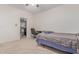 Bedroom includes a large closet, neutral carpeting, a desk, and queen size bed perfect for a home office at 14107 W Christy Dr, Surprise, AZ 85379