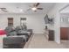 Bonus room with comfy leather recliners, media console, TV and windows, creating a cozy entertainment space at 14107 W Christy Dr, Surprise, AZ 85379