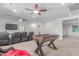 Bonus room offers a TV, tiered seating, and a game table, perfect for movie nights and entertaining at 14107 W Christy Dr, Surprise, AZ 85379