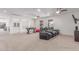 Bonus room for entertaining with black leather recliners, mounted TV, a foosball table, and upstairs landing at 14107 W Christy Dr, Surprise, AZ 85379