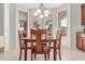 A cozy dining area with wooden table and chairs, and a view to the covered patio at 14107 W Christy Dr, Surprise, AZ 85379