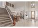 Grand entryway featuring a staircase, dining area, and a glimpse of the living room, highlighting the open layout at 14107 W Christy Dr, Surprise, AZ 85379