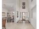 Elegant foyer with soaring ceilings, a grand chandelier, and tile flooring, creating a welcoming atmosphere at 14107 W Christy Dr, Surprise, AZ 85379