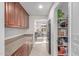 Bright hallway with wood cabinets and granite counters leading to the kitchen and living area at 14107 W Christy Dr, Surprise, AZ 85379