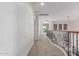 Upstairs hallway with carpet and wood railings leads to bedrooms, with a window seat adding charm at 14107 W Christy Dr, Surprise, AZ 85379