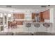 Gourmet kitchen with wooden cabinetry, granite countertops, stainless steel appliances, and dining area, ideal for culinary enthusiasts at 14107 W Christy Dr, Surprise, AZ 85379