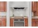 A well-equipped kitchen with granite counters, wooden cabinets, and modern appliances at 14107 W Christy Dr, Surprise, AZ 85379