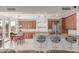 Well-appointed kitchen featuring wood cabinets, stainless appliances, granite counters, bar seating, and an adjacent dining space at 14107 W Christy Dr, Surprise, AZ 85379