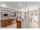 Open-concept kitchen with stainless steel appliances seamlessly connects to the dining area at 14107 W Christy Dr, Surprise, AZ 85379