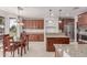 Open-concept kitchen with wooden cabinets, granite counters, stainless appliances, and adjacent dining area, offering ample counter space at 14107 W Christy Dr, Surprise, AZ 85379