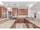 A kitchen boasts wooden cabinets, granite countertops and stainless steel appliances at 14107 W Christy Dr, Surprise, AZ 85379