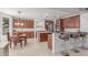 Spacious kitchen with wooden cabinets, granite countertops, stainless steel appliances, and dining table, perfect for Gathering gatherings at 14107 W Christy Dr, Surprise, AZ 85379