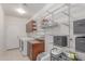 Functional laundry room with ample shelving, storage cabinets, and modern washer and dryer at 14107 W Christy Dr, Surprise, AZ 85379