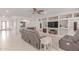Spacious living room with built-in shelving, neutral paint, and comfortable seating, creating a welcoming and airy atmosphere at 14107 W Christy Dr, Surprise, AZ 85379