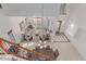 Bright, open-concept living room with high ceilings, neutral decor, and tile flooring, viewed from above the staircase at 14107 W Christy Dr, Surprise, AZ 85379