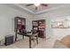 Well-lit office with a desk, storage, and a cozy sofa; ideal for a productive workspace at 14107 W Christy Dr, Surprise, AZ 85379