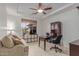 Bright office space with a large window, comfortable seating, desk, and built-in storage at 14107 W Christy Dr, Surprise, AZ 85379