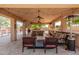 Inviting covered patio with bar, built-in grill, ceiling fans, heaters, and outdoor seating at 14107 W Christy Dr, Surprise, AZ 85379