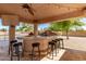 Covered patio with bar and built-in grill at 14107 W Christy Dr, Surprise, AZ 85379