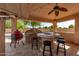 Covered patio with bar, built-in grill, and fire pit at 14107 W Christy Dr, Surprise, AZ 85379