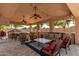 Inviting covered patio with bar, built-in grill, ceiling fans, heaters, and outdoor seating at 14107 W Christy Dr, Surprise, AZ 85379