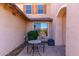 Cozy outdoor patio with wrought iron furniture, perfect for relaxing and enjoying the serene surroundings at 14107 W Christy Dr, Surprise, AZ 85379