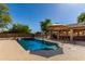 Backyard pool and outdoor kitchen at 14107 W Christy Dr, Surprise, AZ 85379