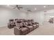 Comfortable home theater room featuring multiple rows of leather recliners and neutral decor at 14107 W Christy Dr, Surprise, AZ 85379
