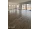 Open living area with wood-look tile floors, white walls, and sliding glass doors to the backyard at 14800 W Lariat Ln, Surprise, AZ 85387