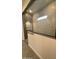 Modern shower featuring patterned tile, a built-in niche, and frameless glass enclosure at 14800 W Lariat Ln, Surprise, AZ 85387