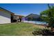 Spacious backyard featuring a pool, patio area, and lush lawn for outdoor activities and relaxation at 15212 N 37Th Ave, Phoenix, AZ 85053