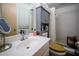 Cozy bathroom featuring a white vanity, storage cabinet and neutral finishes and fixtures at 15212 N 37Th Ave, Phoenix, AZ 85053