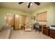 Cozy bedroom with a neutral color scheme, desk, and sliding-door wardrobe at 15212 N 37Th Ave, Phoenix, AZ 85053