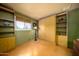 Versatile room features built-in shelving and storage, complemented by a window and laminate flooring at 15212 N 37Th Ave, Phoenix, AZ 85053