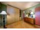 Spacious bedroom featuring built-in storage, a window, laminate flooring, and a dresser at 15212 N 37Th Ave, Phoenix, AZ 85053