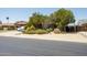 Landscaped front yard with mature trees, desert plants, and a charming single-story home at 15212 N 37Th Ave, Phoenix, AZ 85053