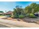 Inviting single-story home with lush, mature landscaping and a convenient covered carport at 15212 N 37Th Ave, Phoenix, AZ 85053