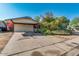 Single-story home boasts a covered carport and an expansive driveway leading to the entrance at 15212 N 37Th Ave, Phoenix, AZ 85053