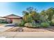Charming single-story home featuring mature landscaping and a welcoming covered carport at 15212 N 37Th Ave, Phoenix, AZ 85053